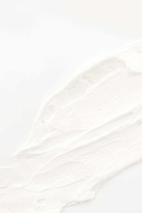 Smeared white cream on a white background