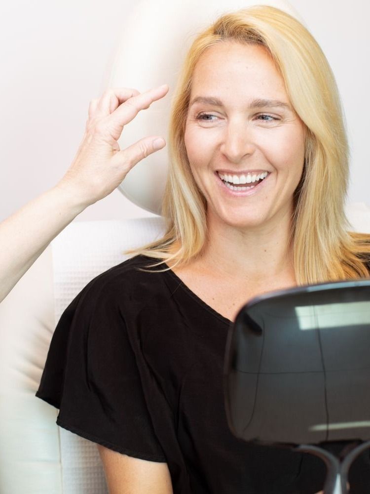 Smiling woman at a beauty consultation appointment.