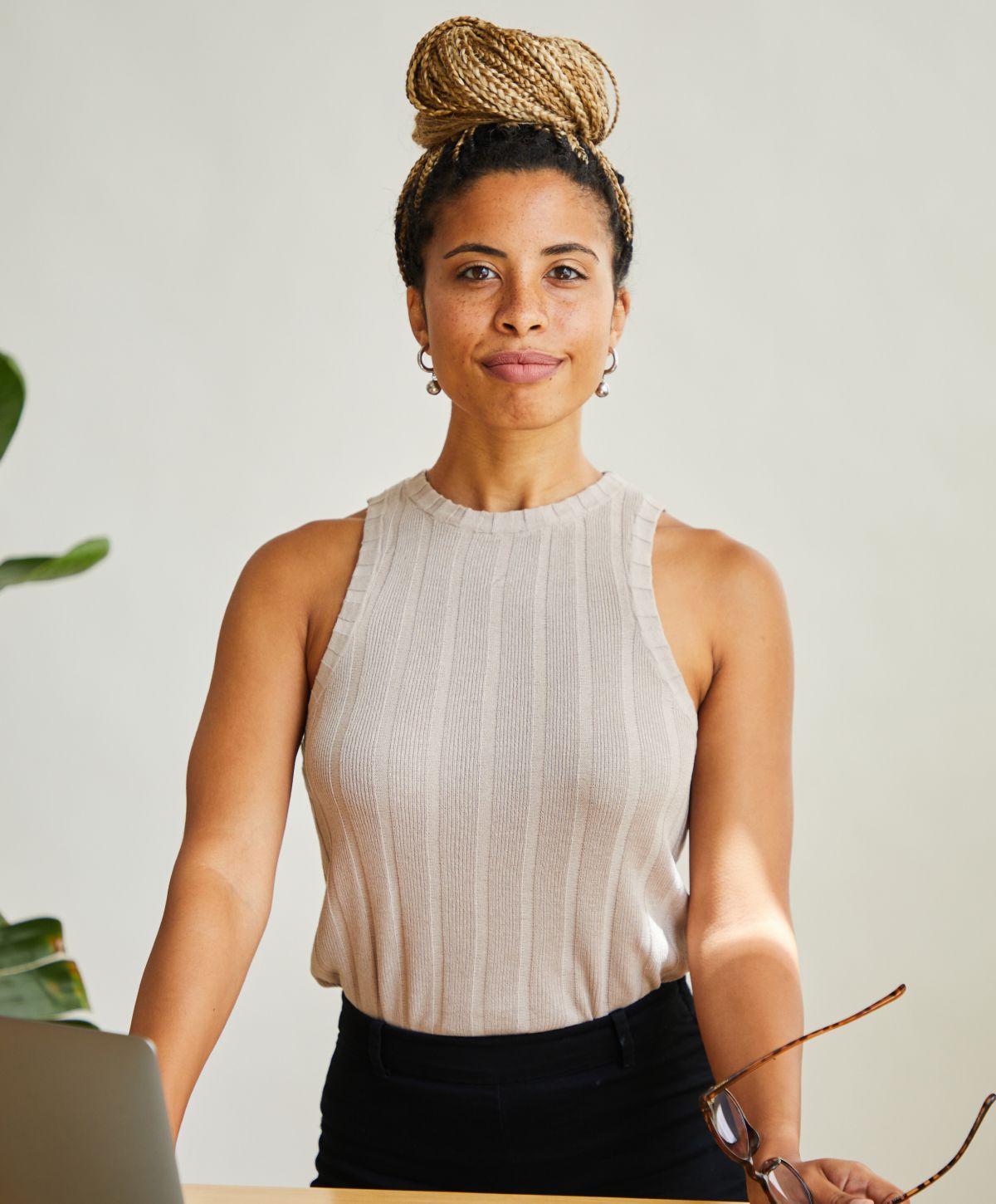 Confident woman standing at a desk.