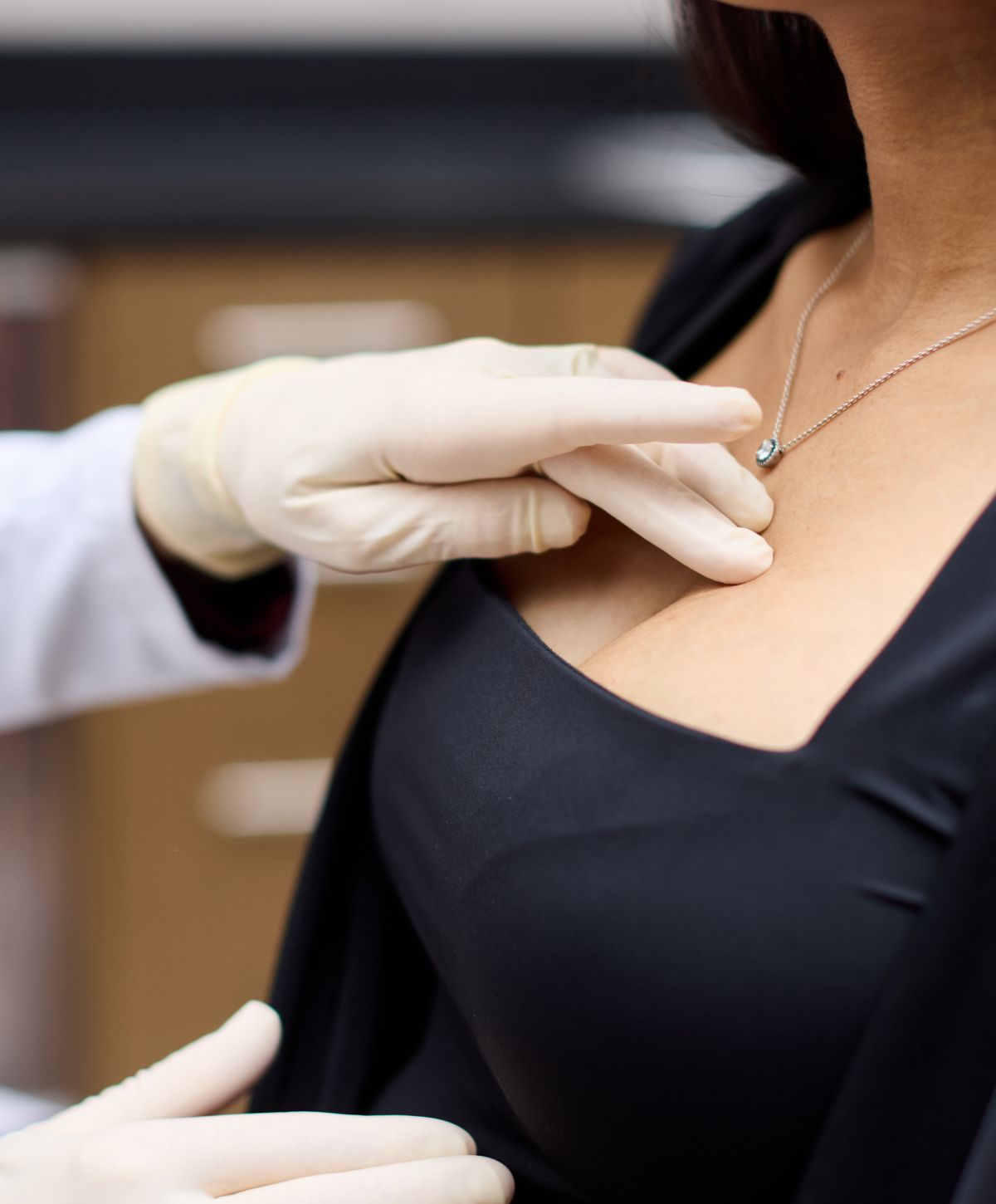 Medical examination with gloved hands on patient.