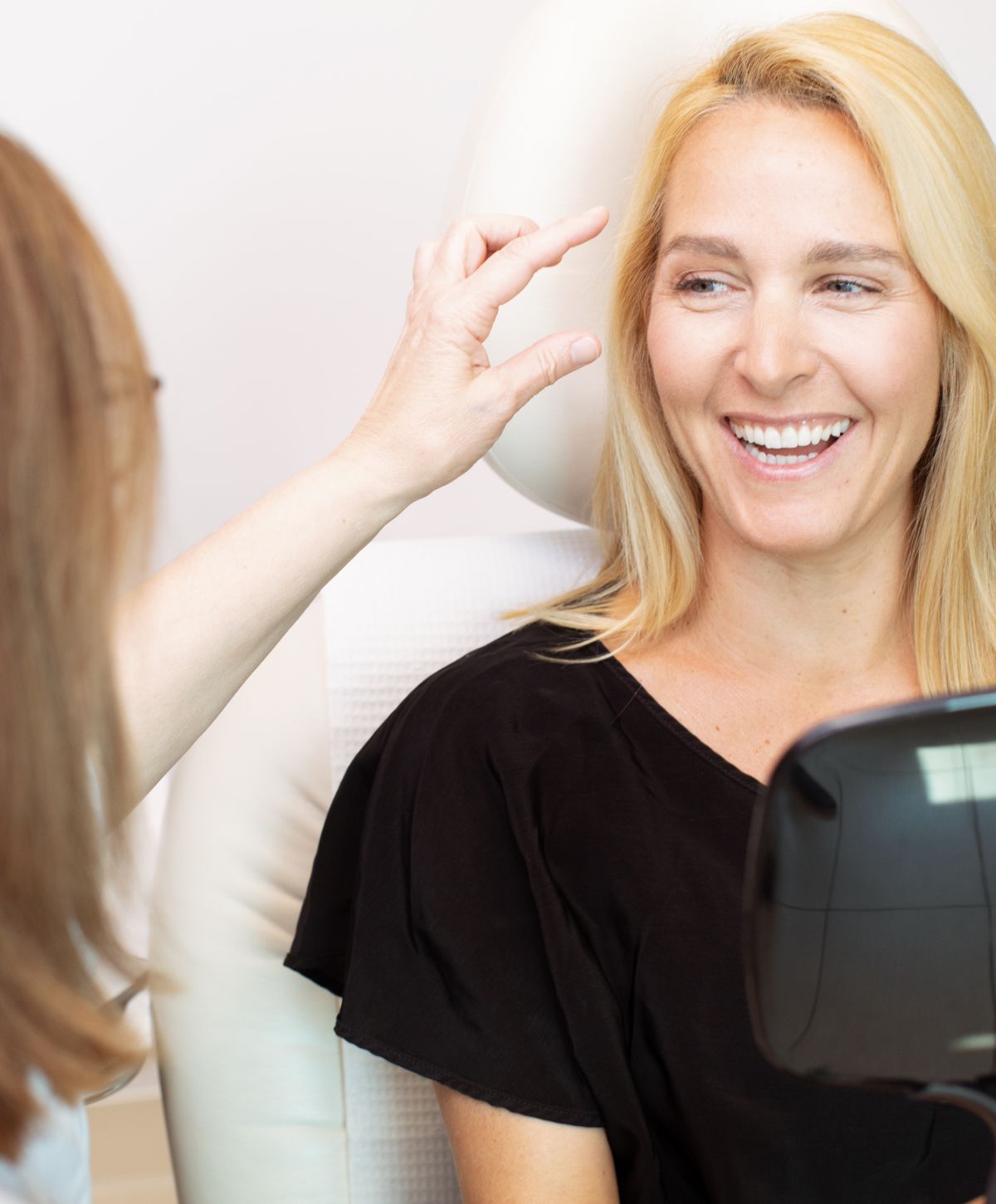 Patient smiling during a beauty consultation.