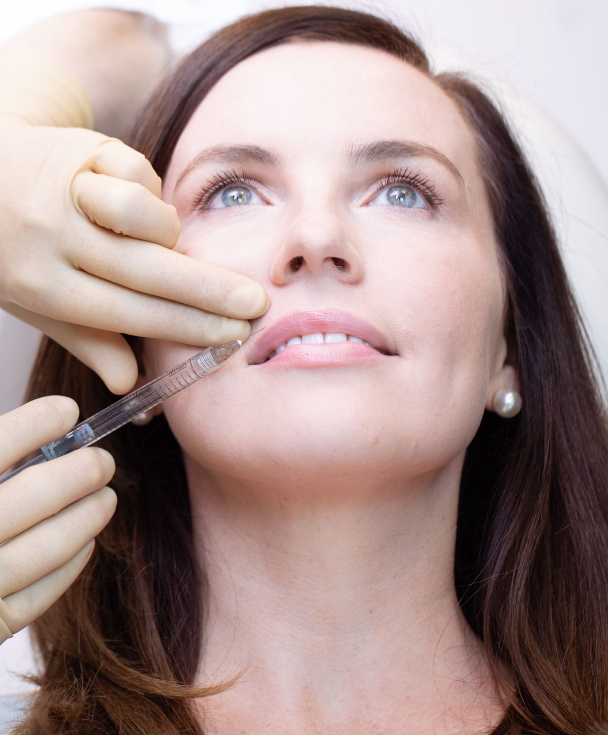 Woman receiving cosmetic injection treatment.