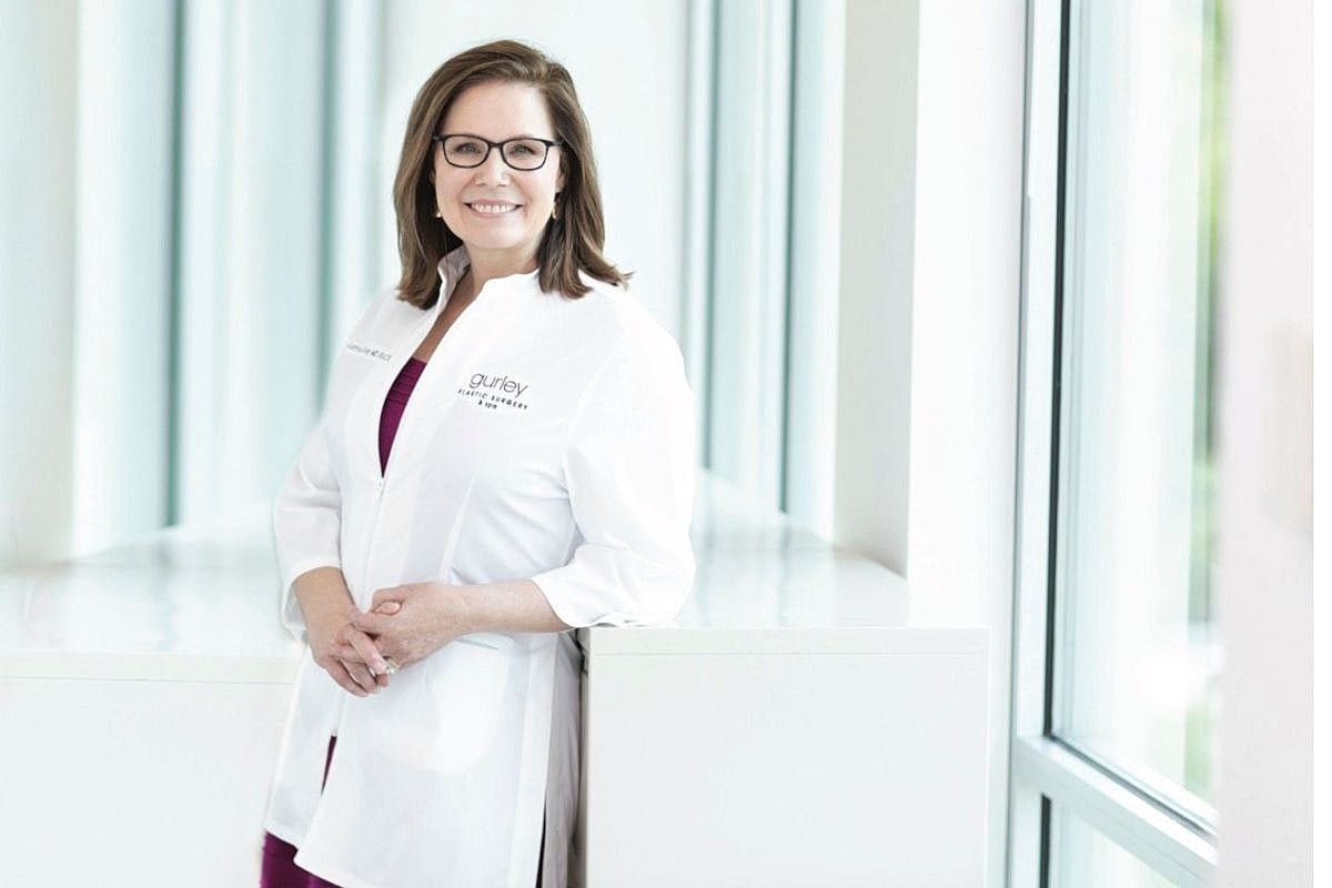 Smiling female doctor wearing lab coat indoors.